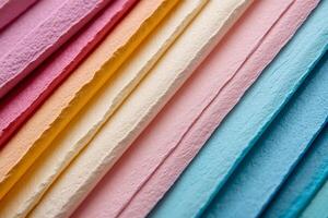 Rainbow-hued textured paper sheets arranged in diagonal lines photo
