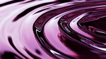 Swirling, glossy, dark pink liquid with concentric ripples photo