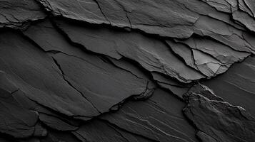 Dark, textured slate surface with layered, rough, fragmented rock photo