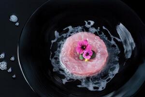 Hand-cut bluefin tuna tartare with hibiscus air and micro-sorrel on elegant porcelain plate photo