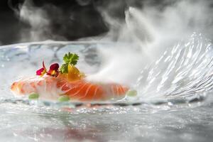 Delicate Arctic char slice enhanced by torched texture and yuzu mist on crystal plate with fresh garnish photo