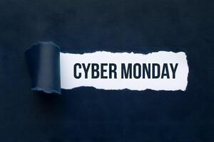 Torn paper piece with CYBER MONDAY text against dark background photo
