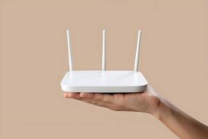 Hand holds Wi Fi router with four antennas, emphasizing connectivity and technological utility photo