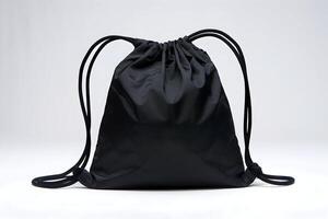 Black drawstring bag rests against white background, showcasing simplicity and practicality photo