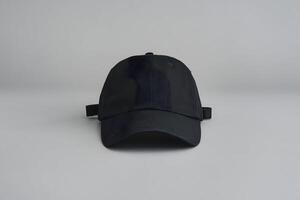 Black cap displayed with curved visor, showcasing practicality and timeless design photo