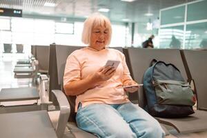 Qr code, check in and man with a phone for a ticket, airplane booking and information at airport. Travel, website and hand of a businessman reading a barcode on a mobile for a work trip or vacation photo