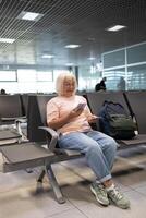 Qr code, check in and man with a phone for a ticket, airplane booking and information at airport. Travel, website and hand of a businessman reading a barcode on a mobile for a work trip or vacation photo