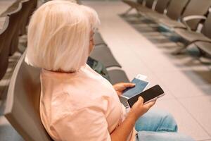 Qr code, check in and man with a phone for a ticket, airplane booking and information at airport. Travel, website and hand of a businessman reading a barcode on a mobile for a work trip or vacation photo