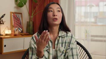 Overheated Asian Korean Chinese Japanese woman waving hand refresh tired lady sweaty female girl suffer of high temperature problem feel sweat hot without air conditioner climate control home indoors video