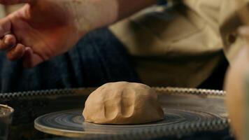 Man master beating ball piece kneading clay throwing pottery wheel preparation for modeling craftsman potter workshop making new work creating pot earthenware artisan shaping sculpting male handmade video