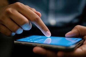 Close-up of hands interacting with a smartphone screen showcasing technology use. photo