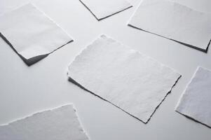 Torn paper pieces with a textured isolate on white background. photo