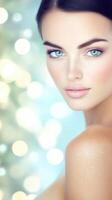 Beautiful woman showing perfect skin and makeup on shiny background photo