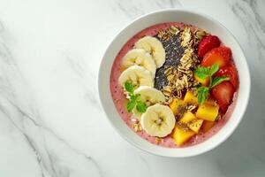 Delicious smoothie bowl with sliced banana, chia seeds and fresh fruits photo