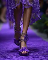 Model walking runway wearing purple lace dress and high heel sandals with flowers and chains photo