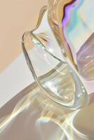 A glass vase with a rainbow reflection on it photo