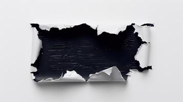 A piece of torn paper with black paint on it photo