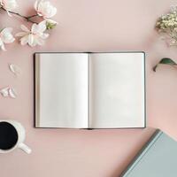 Open book, coffee and flowers on pink background photo
