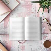 Open notebook, coffee cup, glasses, and book on pink table top view photo