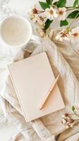 Blank notebook, pen and coffee on a white marble background photo