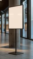 A blank white sign on a stand in an empty room photo