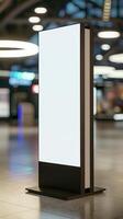 A blank billboard stands in a large airport photo
