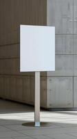 A white sign stands in front of a building photo