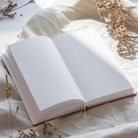 An open book on a bed with dried flowers photo