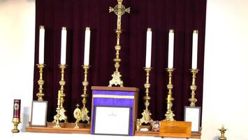 a church altar with several candles and a cross photo