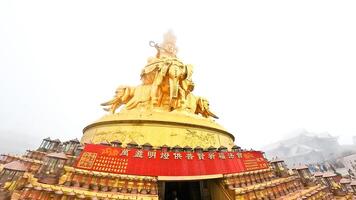 a golden statue of buddha in the middle of a crowd photo