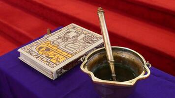 a bucket with a book and a spoon on a table photo