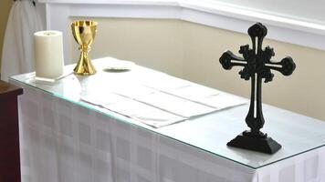 a cross on a table with a white cloth and a gold cross photo