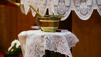 a gold cup on a table with a lace table cloth photo