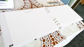 a notebook with a pen and a pen on a table photo