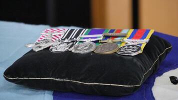 a pillow with medals on it sitting on a table photo