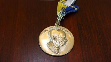 shot of a medal with a portrait of a man on it photo