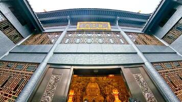 the entrance to a large building with a large statue photo