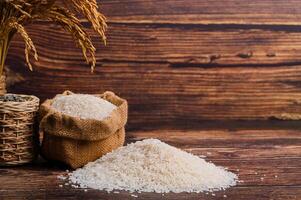 Natural Rice and Ear with Rustic Background on Wooden Surface photo