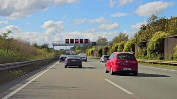 Amsterdam. Netherlands 11.11.2024 Busy Dutch highway with cars and speed limit signs, modern road infrastructure under a blue sky video