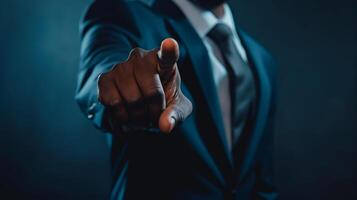 A man in a suit pointing at something photo