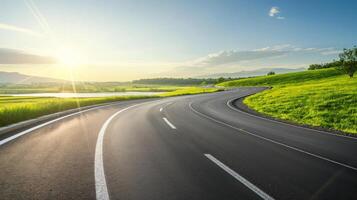 An empty road with a sun shining in the background photo