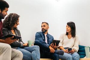 Group of multiracial people working with devices in a coworking photo