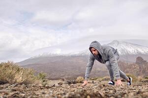 Man getting ready for running in mountains photo
