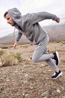 man running in rocky fields photo