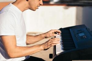 man playing piano on an urban rooftop. photo