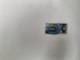 power electric wire in hole hub on wall background photo