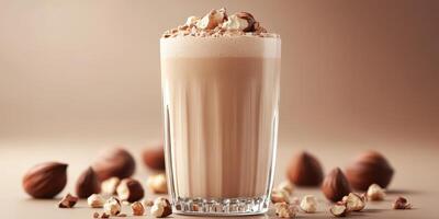 Creamy chocolate beverage topped with nuts served in a glass on a neutral background photo