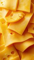 Slices of yellow cheese stacked on top of each other, showcasing texture and holes in the cheese photo