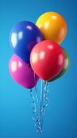Colorful balloons floating against a bright blue background create a festive and cheerful atmosphere for celebration photo