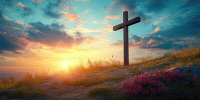 Cross standing on a hill at sunset surrounded by flowers and sky filled with clouds photo